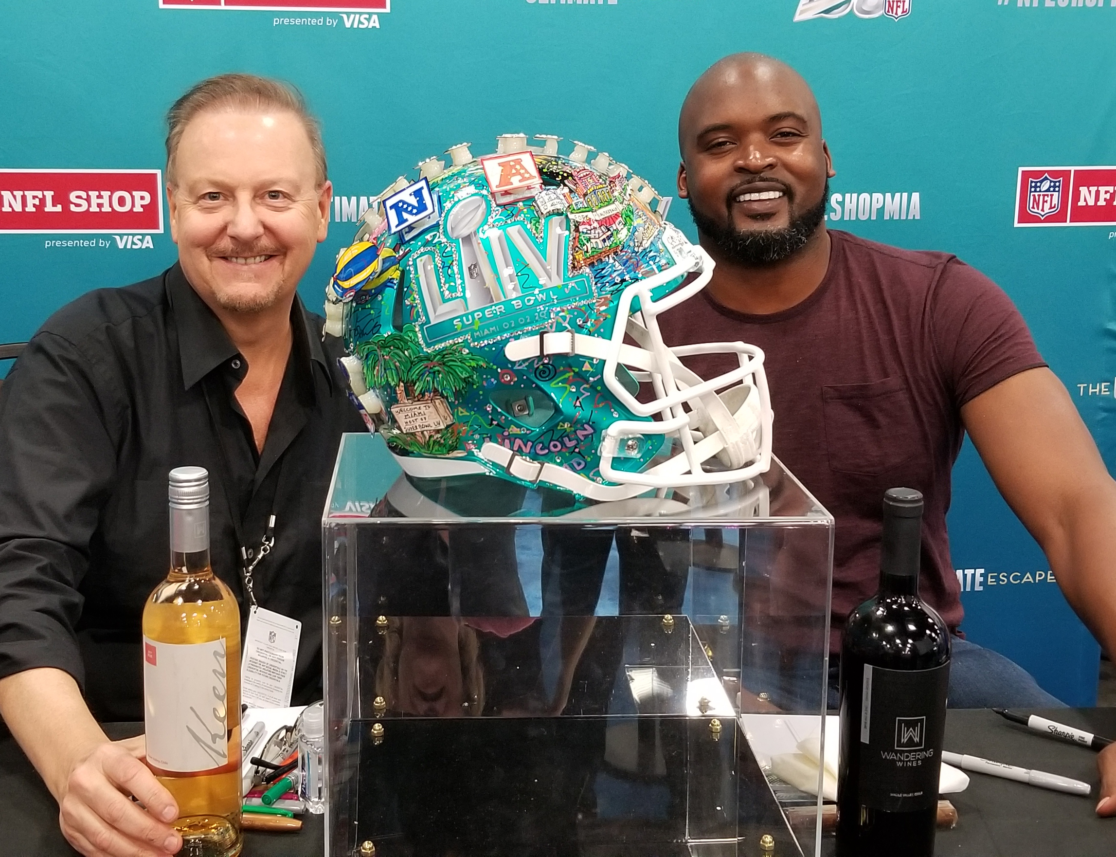 Charles Fazzino with Former NY Giant Mathias Kiwanuka, pictured with Super Bowl helmet and wine.