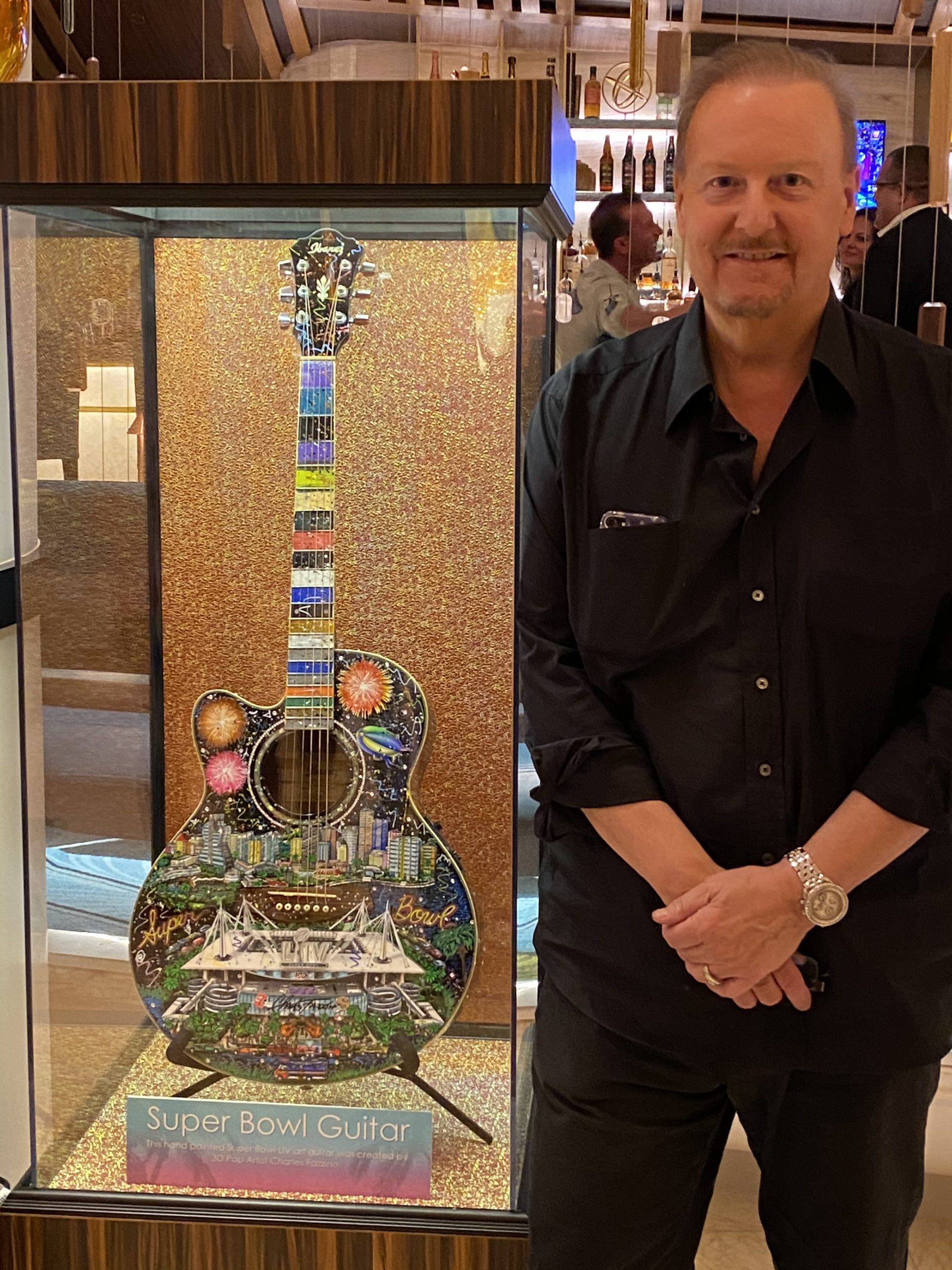 Fazzino standing next to his Super Bowl Guitar