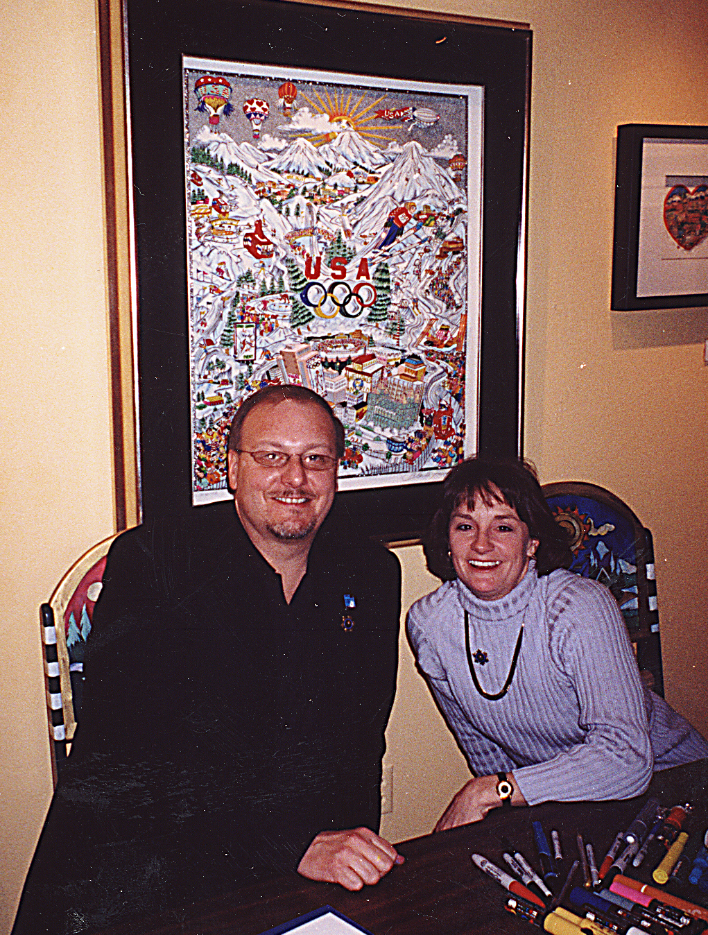 Charles Fazzino and Olympic Gold Medalist Bonnie Blair signing Olympic pop art posters at the 2002 Olympic Games in Salt Lake City