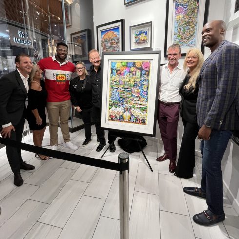 Charles Fazzino with Emmanuel Ogbah,, Mathias Kiwanuka, and Winterfest President & CEO, Lisa Scott unveiling the 50th Anniversary of the Winterfest Boat Parade artwork 