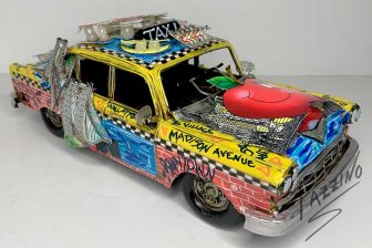 yellow taxi cab sculpture featuring NYC landmarks