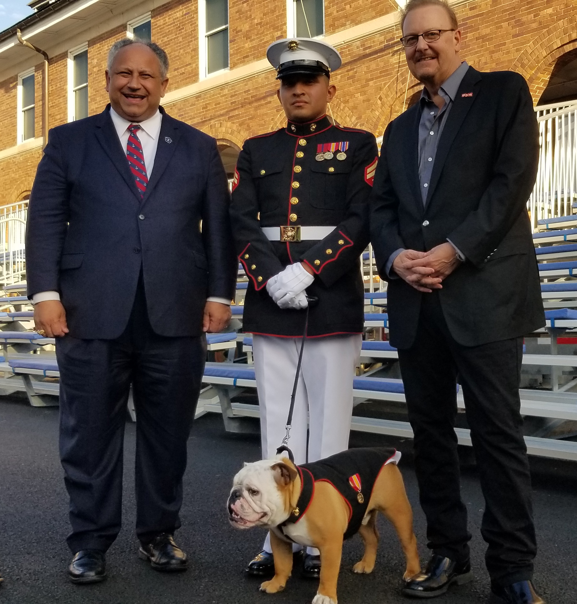 Secretary of the Navy Carlos DelToro and Chesty XVI, official mascot of the US Marine Corp. with Charles Fazzino at 75th Annual Toys for Tots foundation ceremony