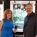 Charles Fazzino and Liz Claman stand in front of colorful art piece