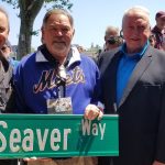 Charles Fazzino, Ron Swoboda, Jerry Koosman, and Cleon Jones hold a green street sign that says "Seaver Way"