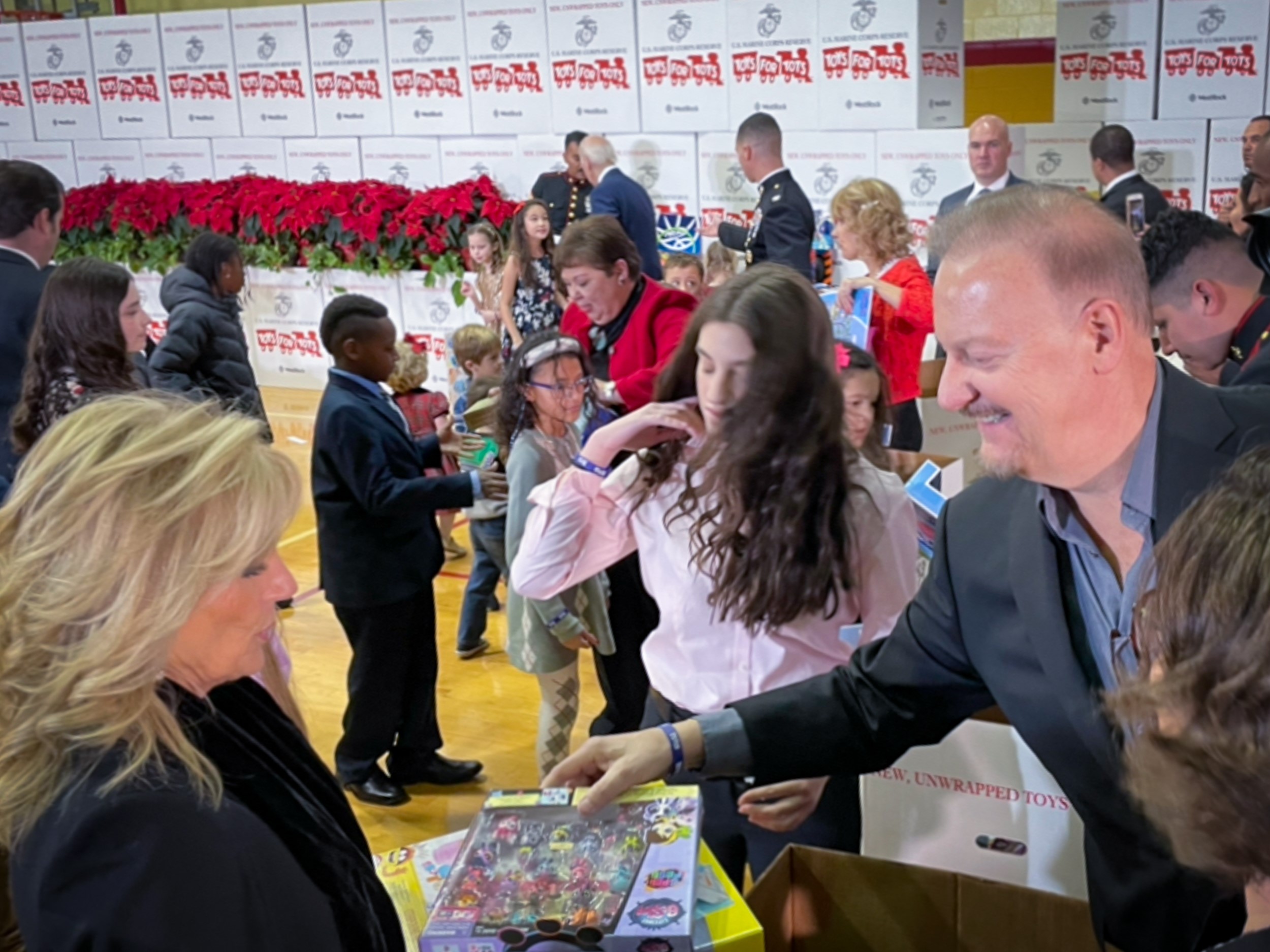 Fazzino passes toys for tots gifts to the First Lady