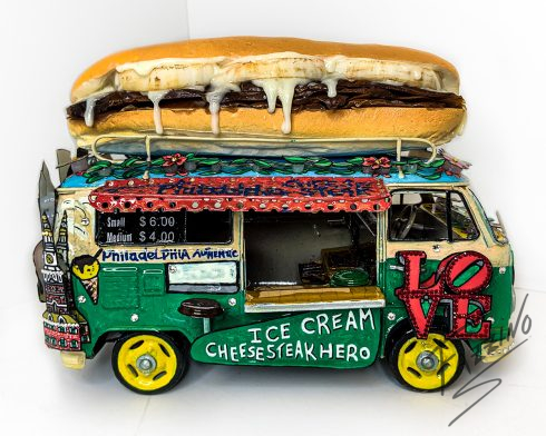 philly cheesesteak vw bus, featuring a cheesesteak on the roof and a foodtruck style design