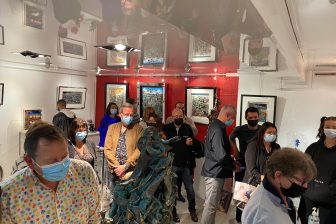 A crowd of people gathered at an art gallery in Mensing, Germany