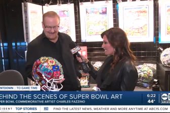 Fazzino holding the Super Bowl helmet being interviewed before the game