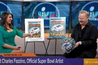 Fazzino on NBC News with his artwork and poster for Super Bowl LVII holding the helmet and talking to a reporter about how it was made