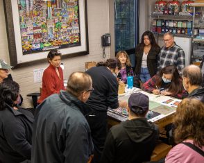 A group gathers in the studio to look at artwork in the making at the Fazzino studio during ArtsFest