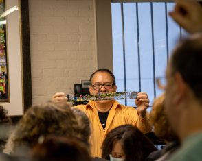 Holding up a cut out from a print of Fazzino's artwork