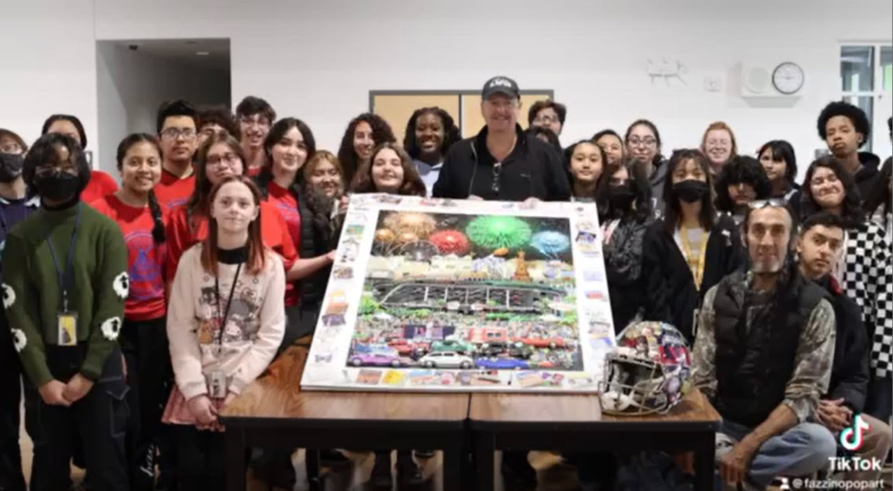 A big group of art students pose with the artwork they created of the Super Bowl alongside the artist Fazzino at a interactive workshop