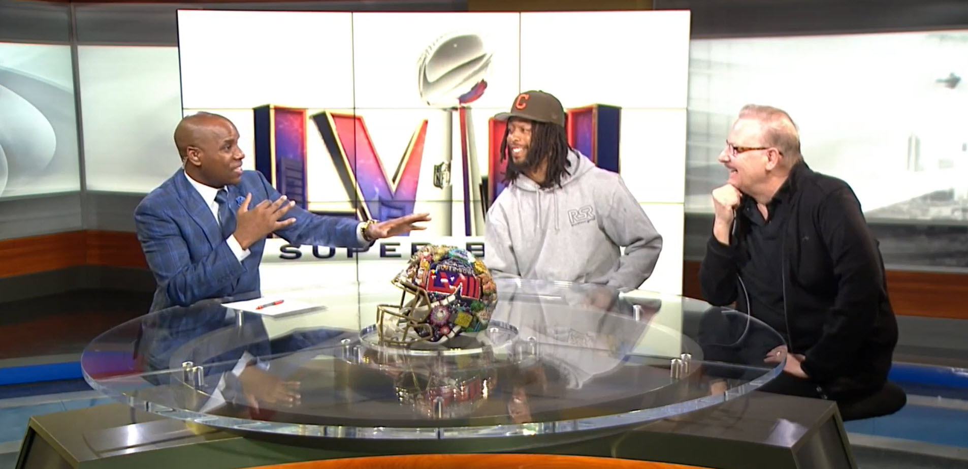 Fazzino on the set of NBC news in Las Vegas presenting his Super Bowl LVIII helmet along with Jakobi Meyers