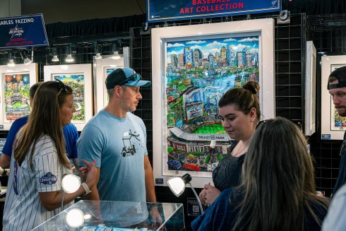 People gather around the Fazzino booth at the All-Star Village