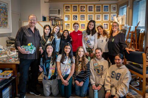 Charles stands alongside a group of Girl Scouts in his New Rochelle art studio