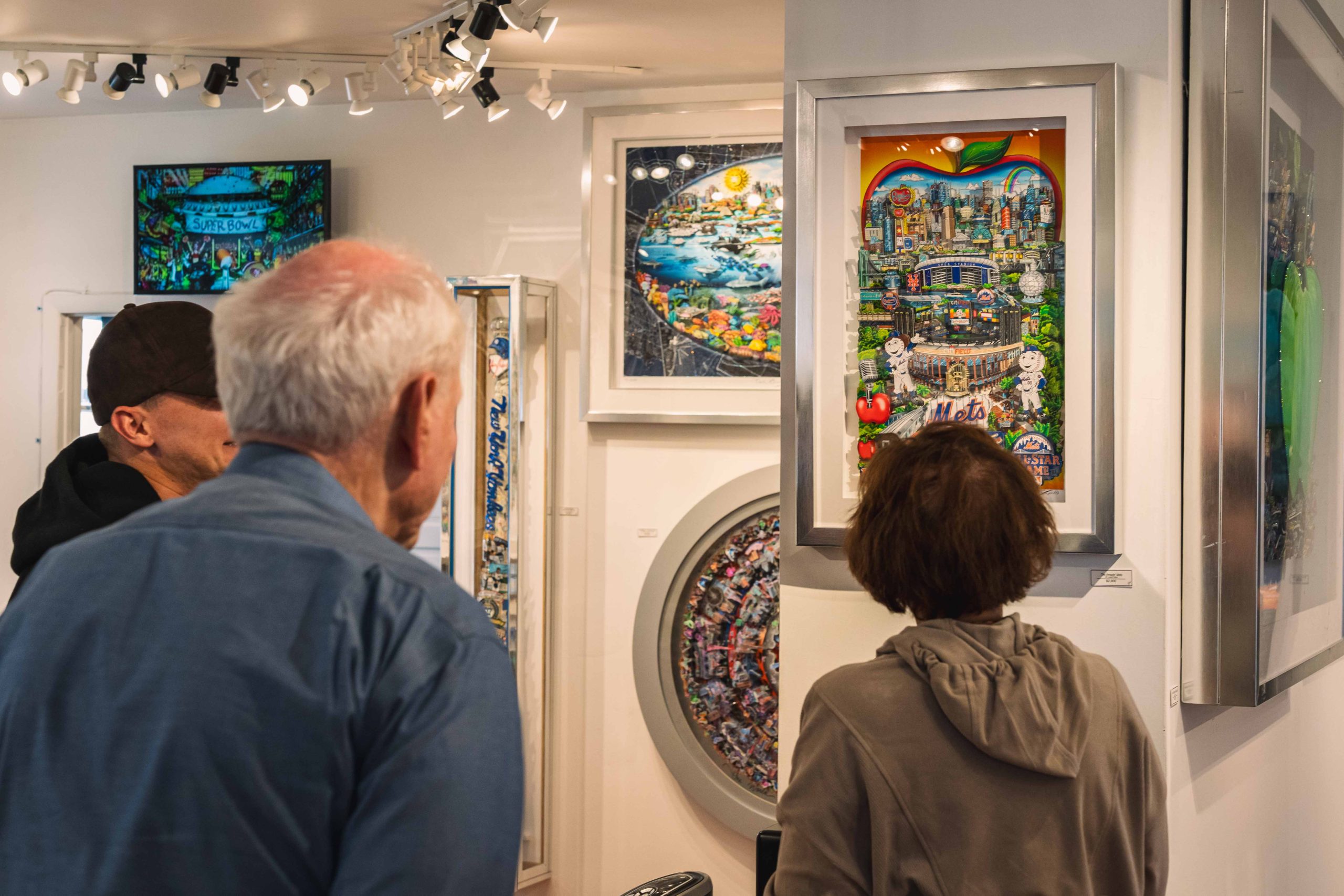People in the Fazzino gallery look at the artwork hanging on display
